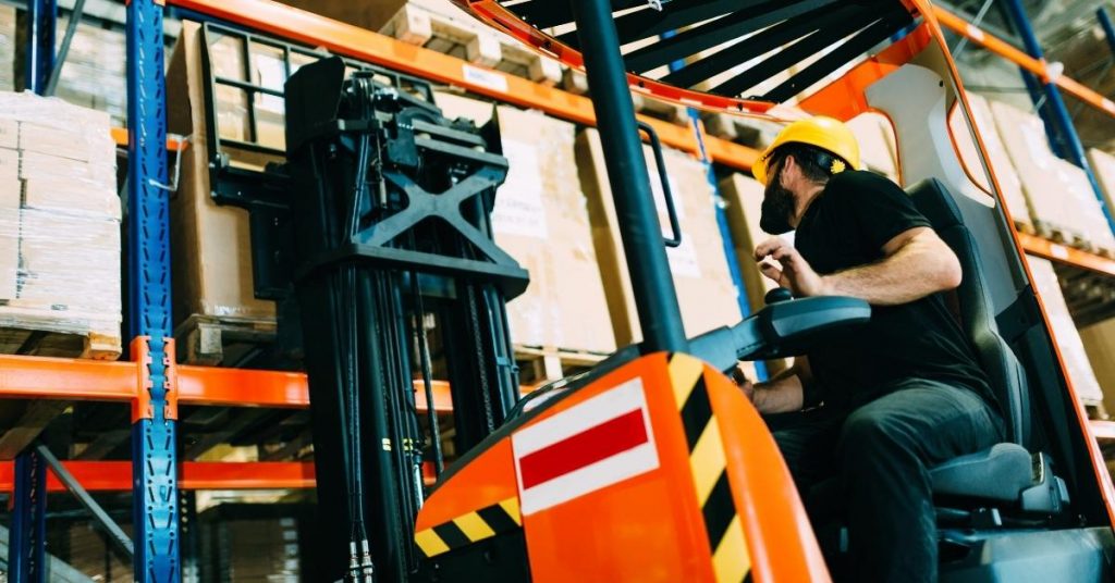 male forklift driver working in a factory