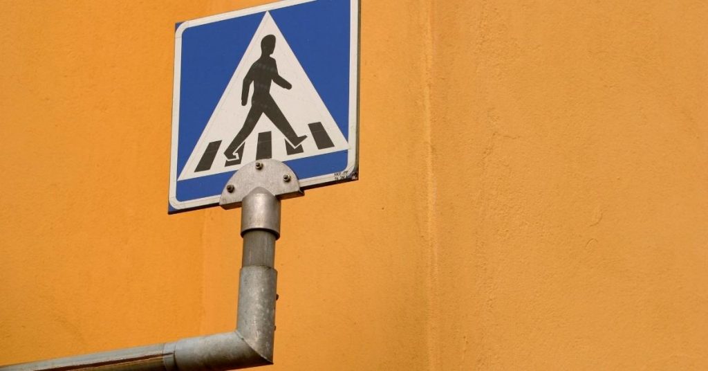 blue metal pedestrian sign