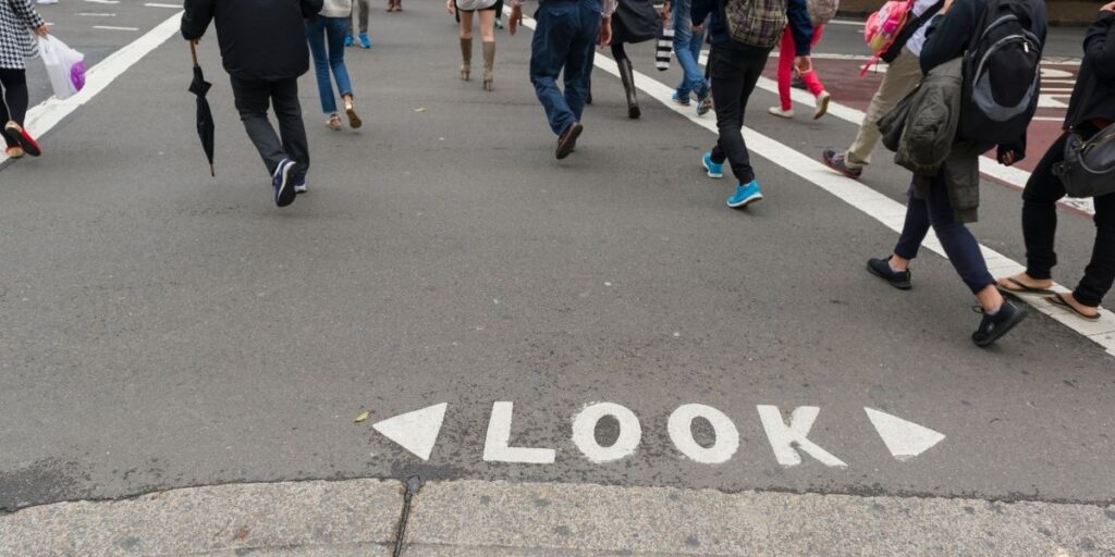 walking people look text on the road