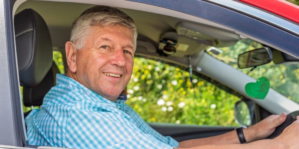 mature man driving a car