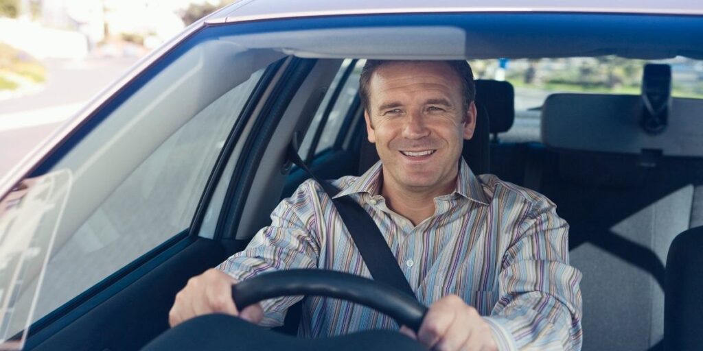 adult man driving a car in australia