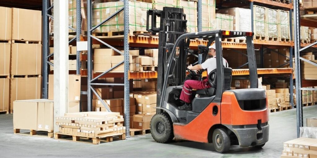 orange forklift works in factory