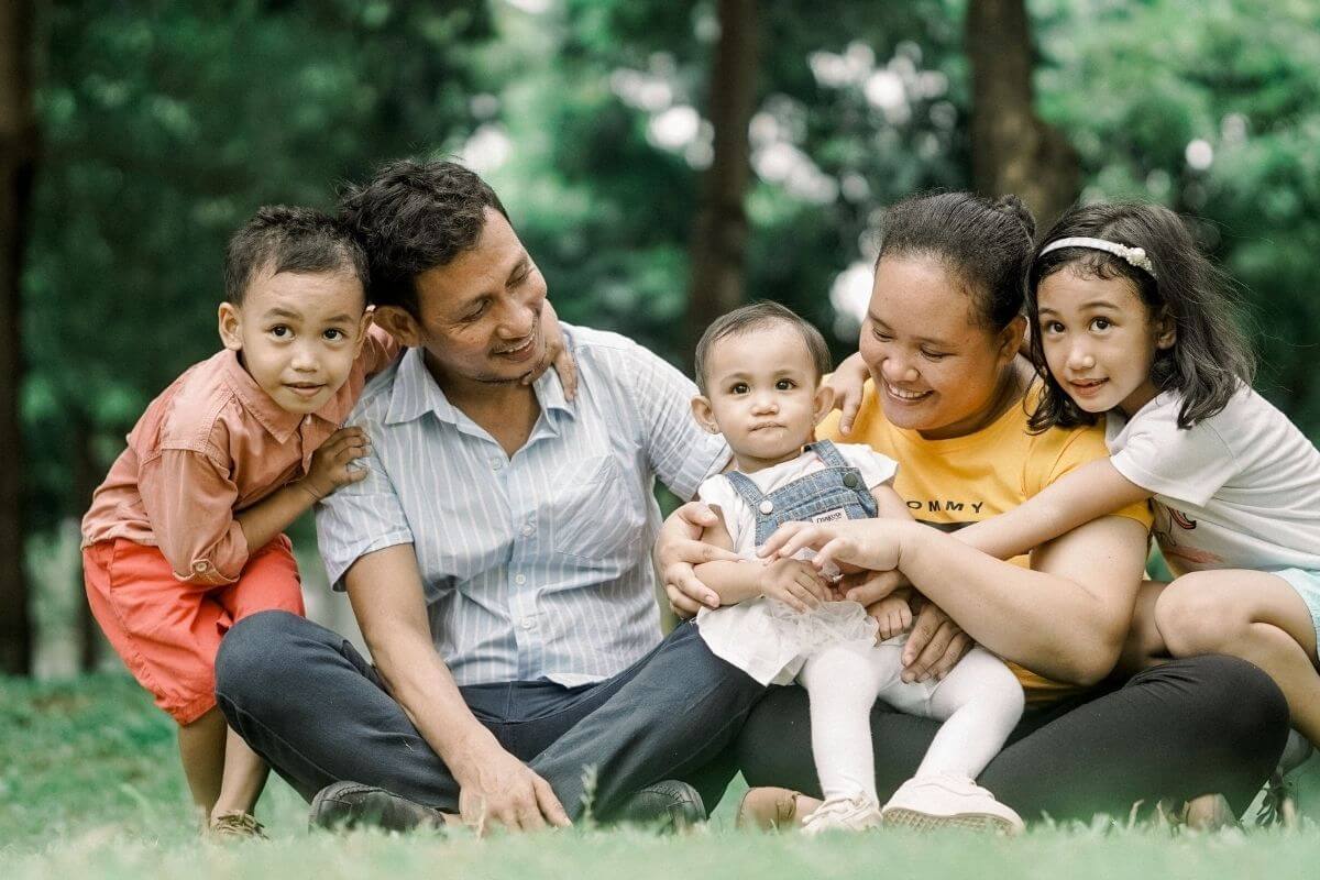 happy big family sitting on the grass