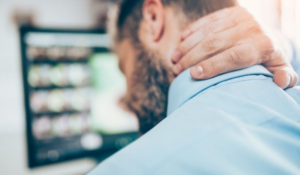 man with a blue shirt has neck pain