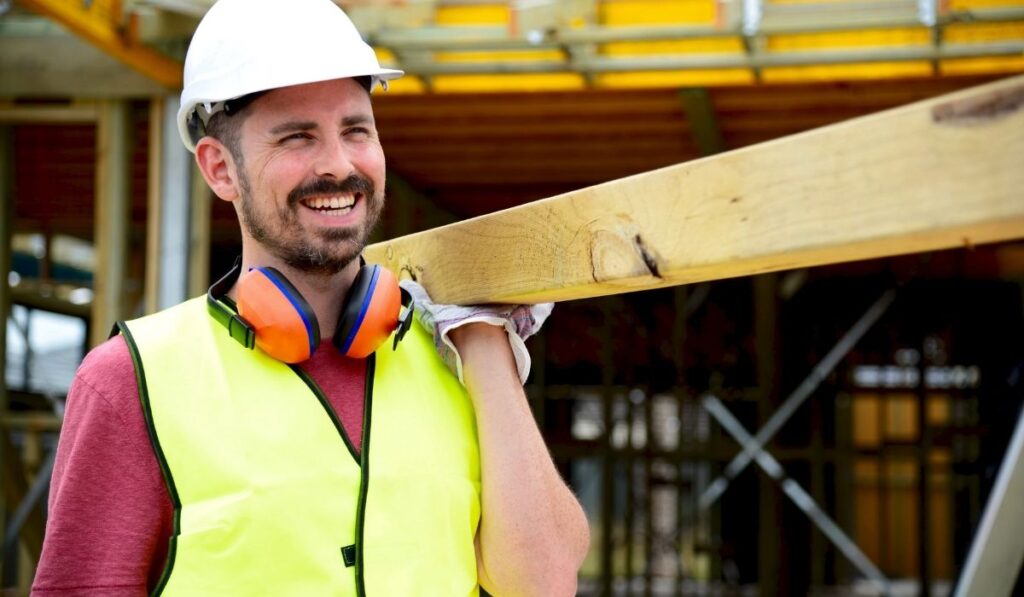 male worker shouldering wooden slat