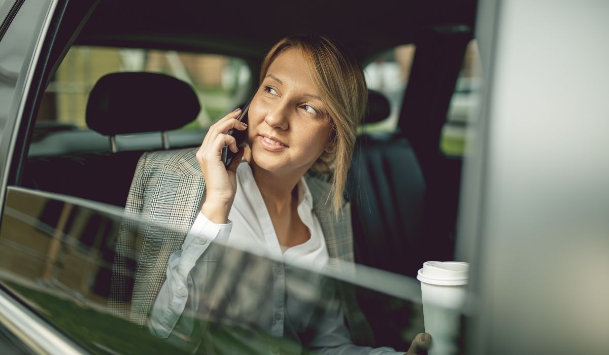 female passenger in a car talking on the phone