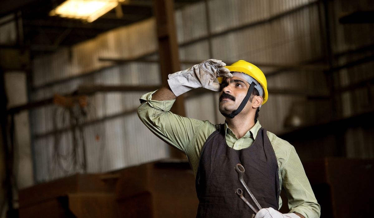 worker looking up holding equipment