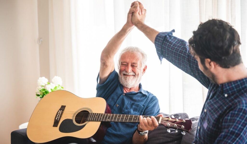 happy old and young man high five