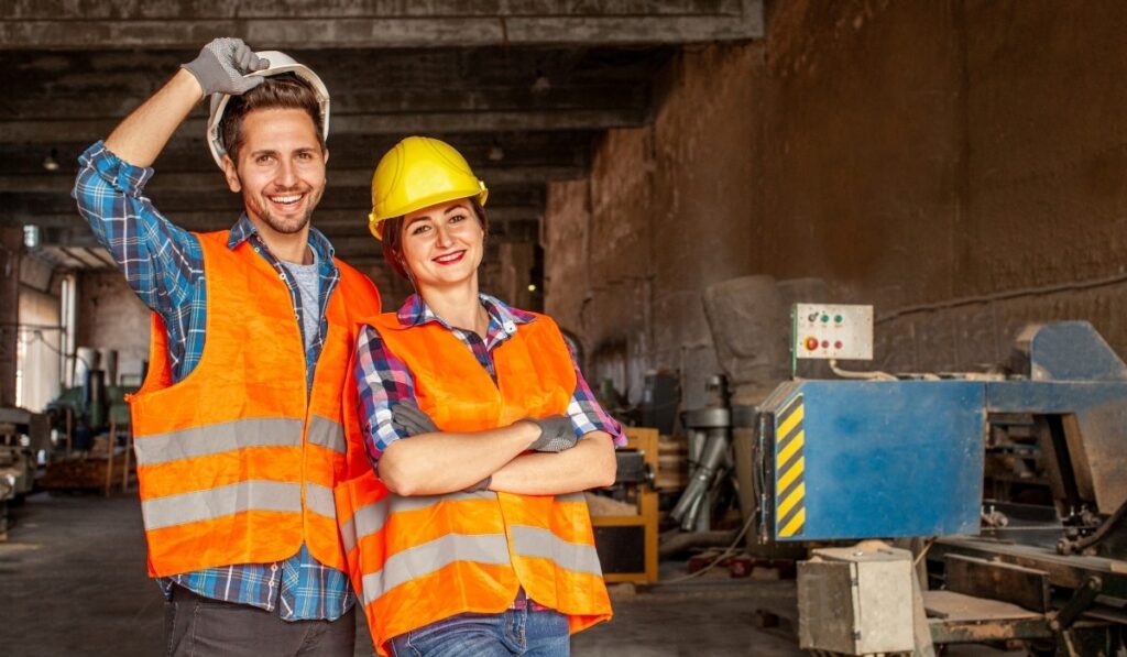 orange jacket workers smiling