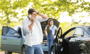 Man thinking what to do after a car accident