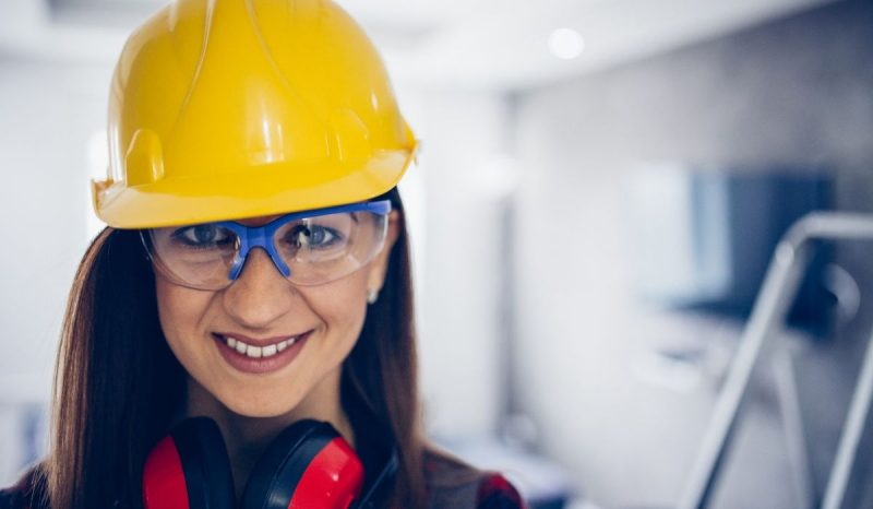 female worker helmet and eye protection