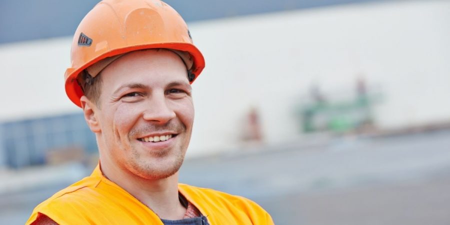 happy worker wearing orange helmet
