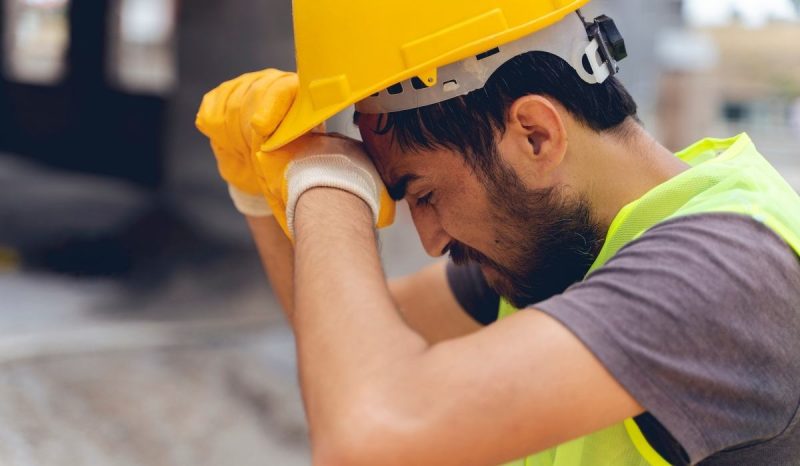 head injury male worker sitting