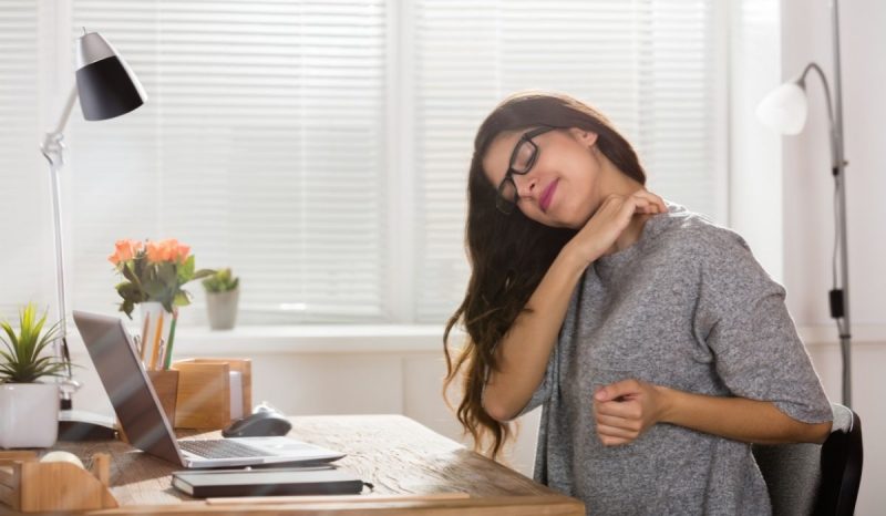 woman at the office suffering neck pain
