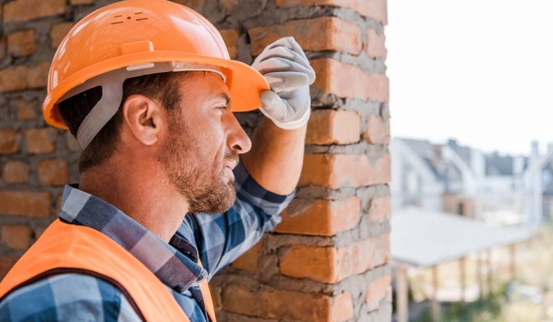 male worker wearing orange helmet to protect head and brain injury