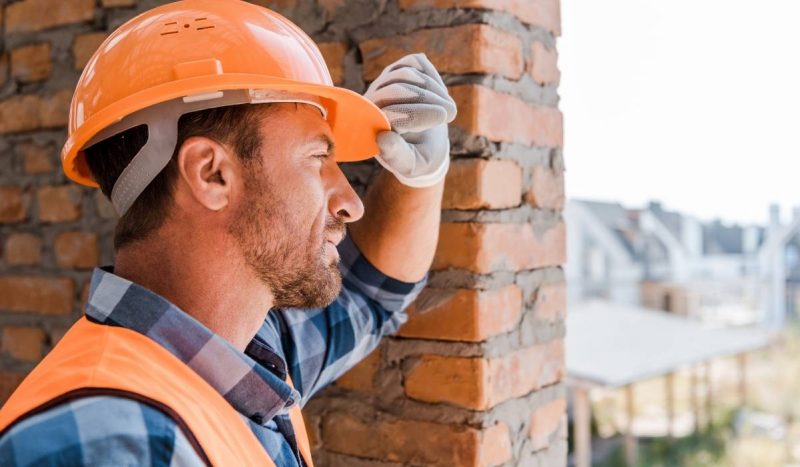 male worker wearing orange helmet to protect head and brain injury