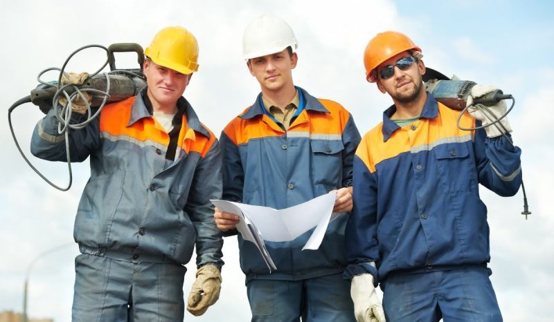 three workers with helmets