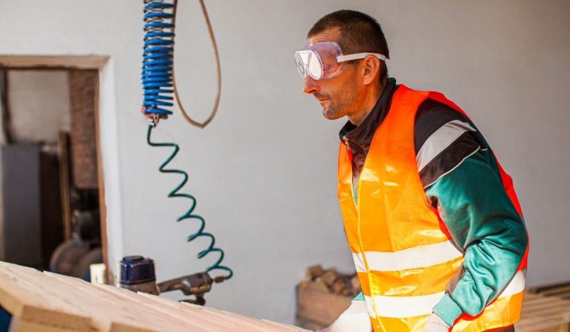 orange jacket male worker with eye protection