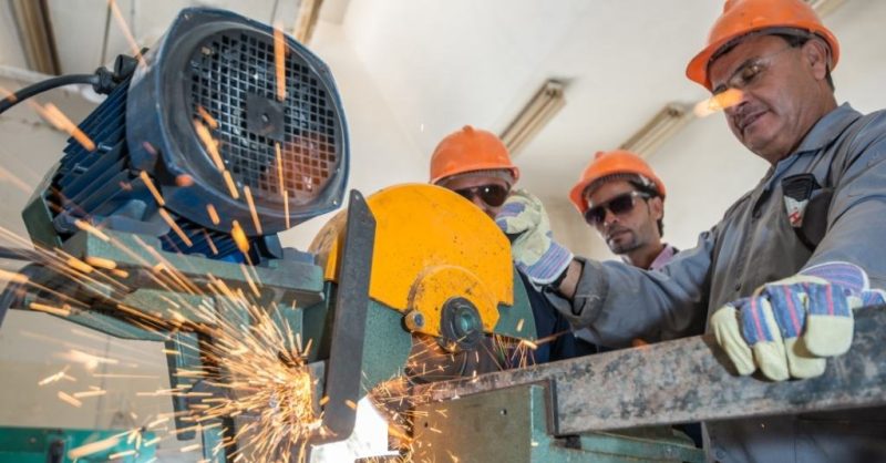 three workers cutting